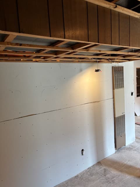 During: drywall panels going up on the basement walls.